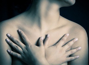 A woman with her hands on her chest